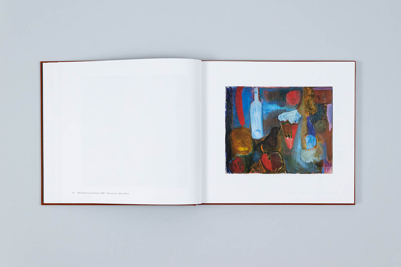 Carole Gibbons monograph showing an oil painting of a bottle, vase, and fruit painted in a mostly blue and red palette