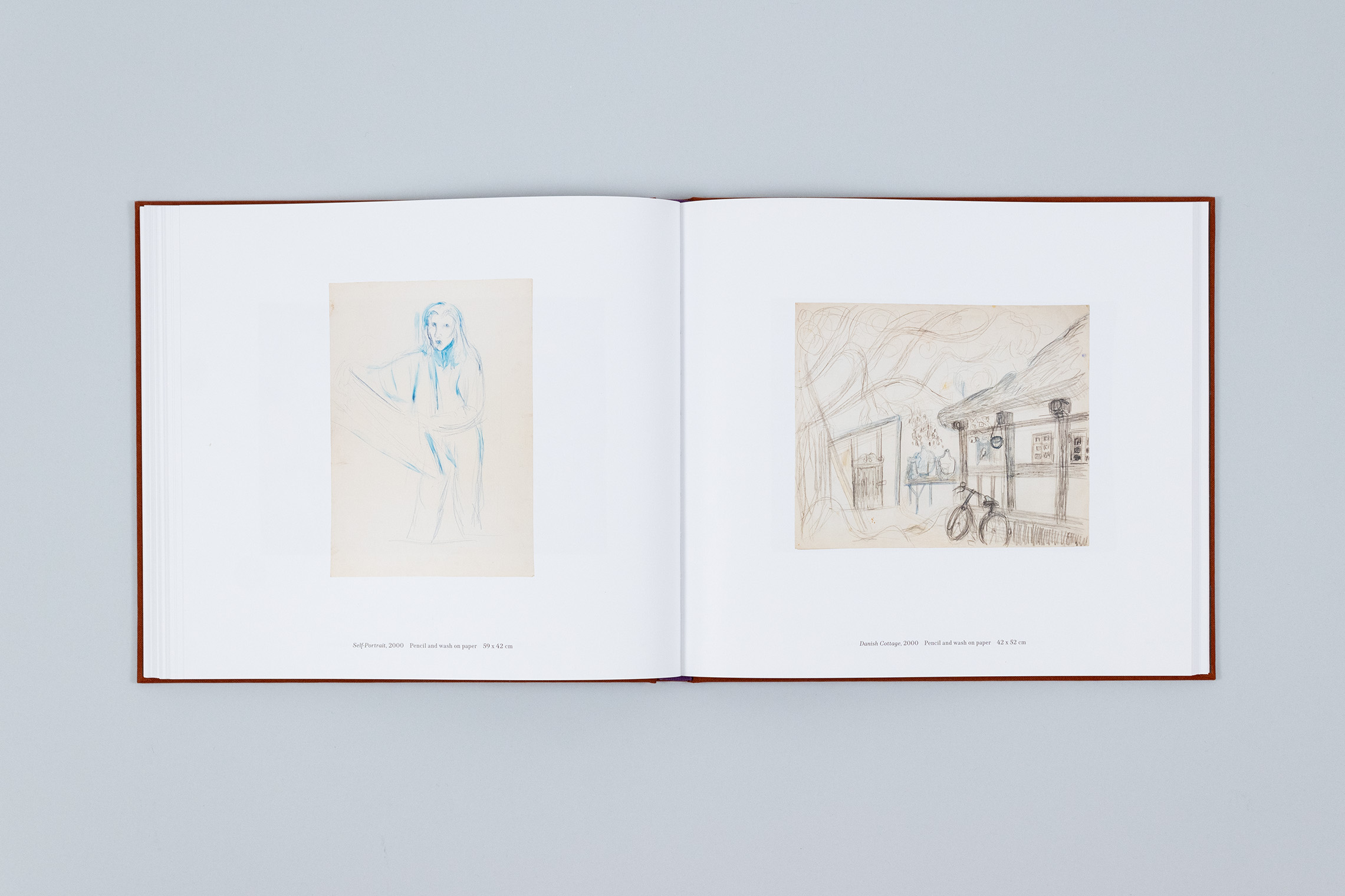 Carole Gibbons monograph spread with two works on paper over the pages, a self-portrait of Gibbons on the left