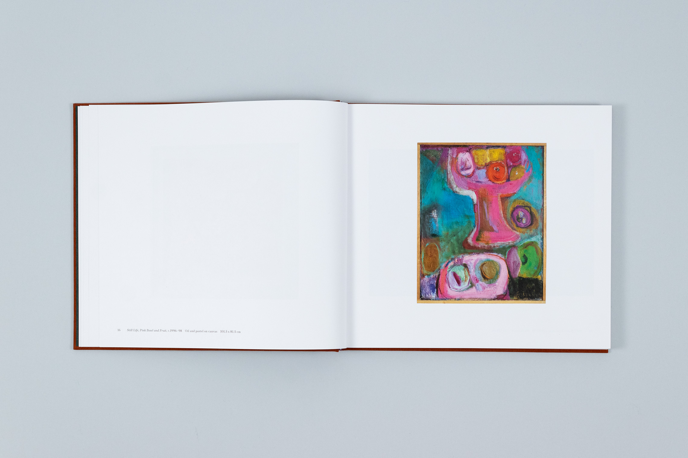 Carole Gibbons monograph spread showing a still life oil painting of fruit on the right page, in vibrant colours with a wooden frame